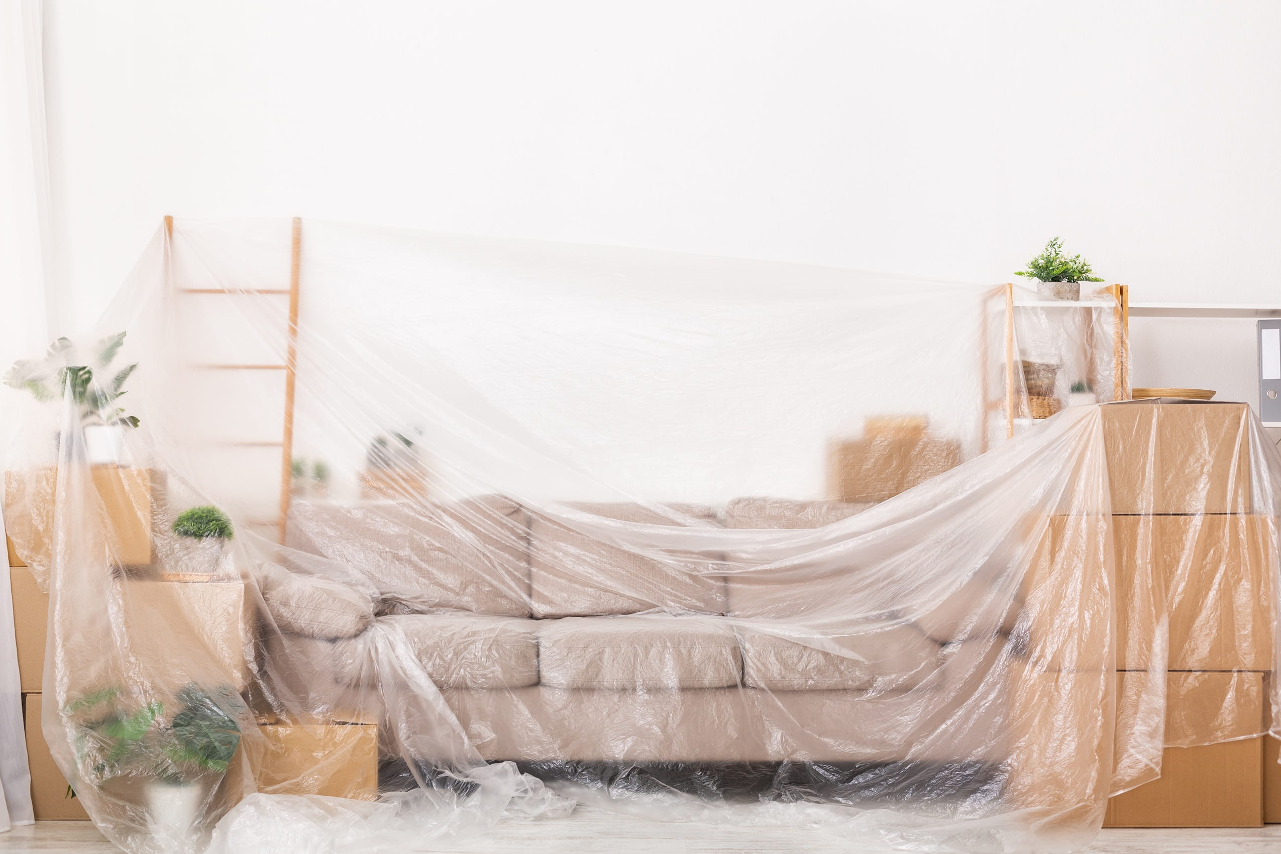 sofa-and-boxes-covered-with-plastic-wrap