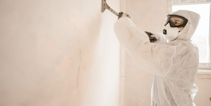 worker-prepares-wall-for-painting-in-protective